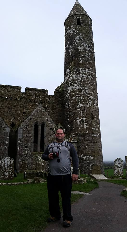 Abe standing with the Rock of Cashel behind him.
