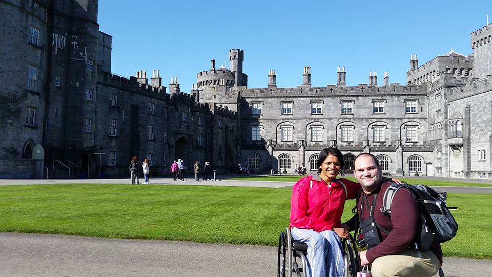 Maggie and Abe posing in front of castle.