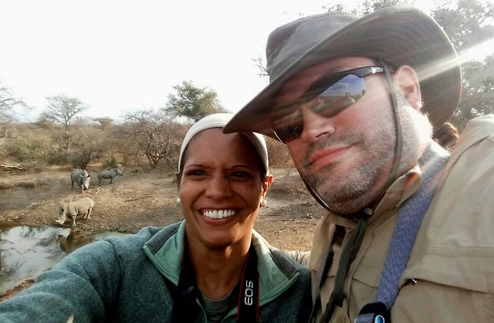 Maggie and Abe with rhinos in the background